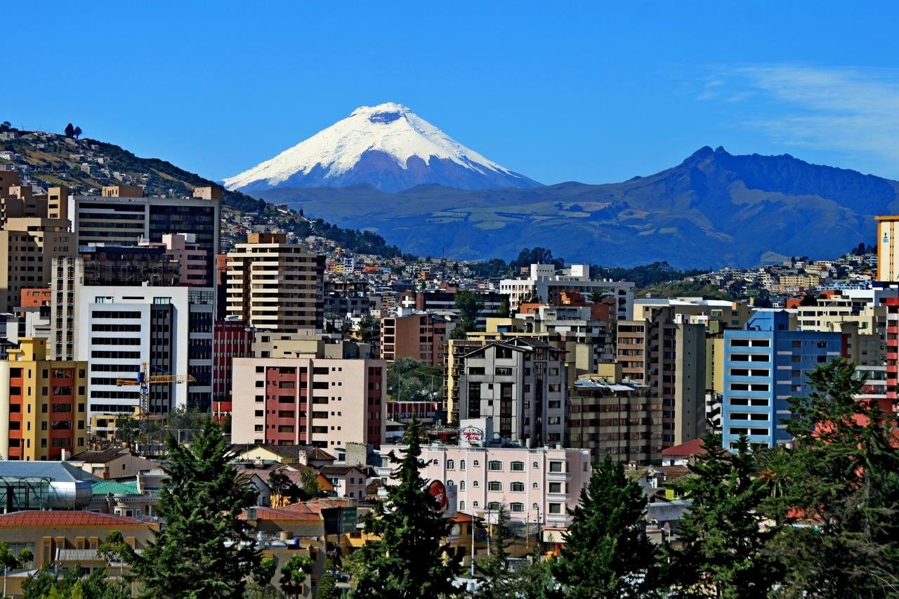 View of Quito with the snow-capped Cotopaxi volcano rising behind the city in the Ecuadorian Andes.