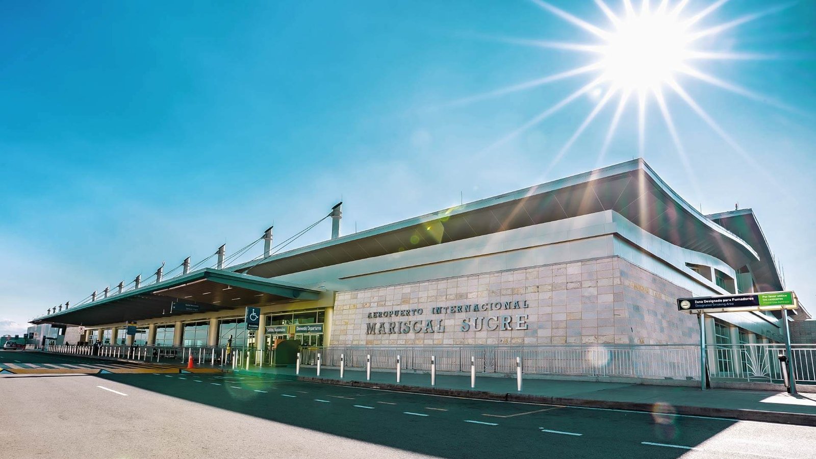 Exterior of Mariscal Sucre International Airport in Quito, Ecuador, under a clear blue sky.