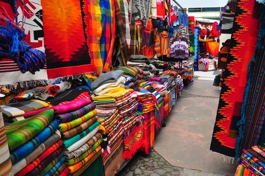 Colorful traditional textiles and handicrafts displayed at Otavalo Market in Ecuador